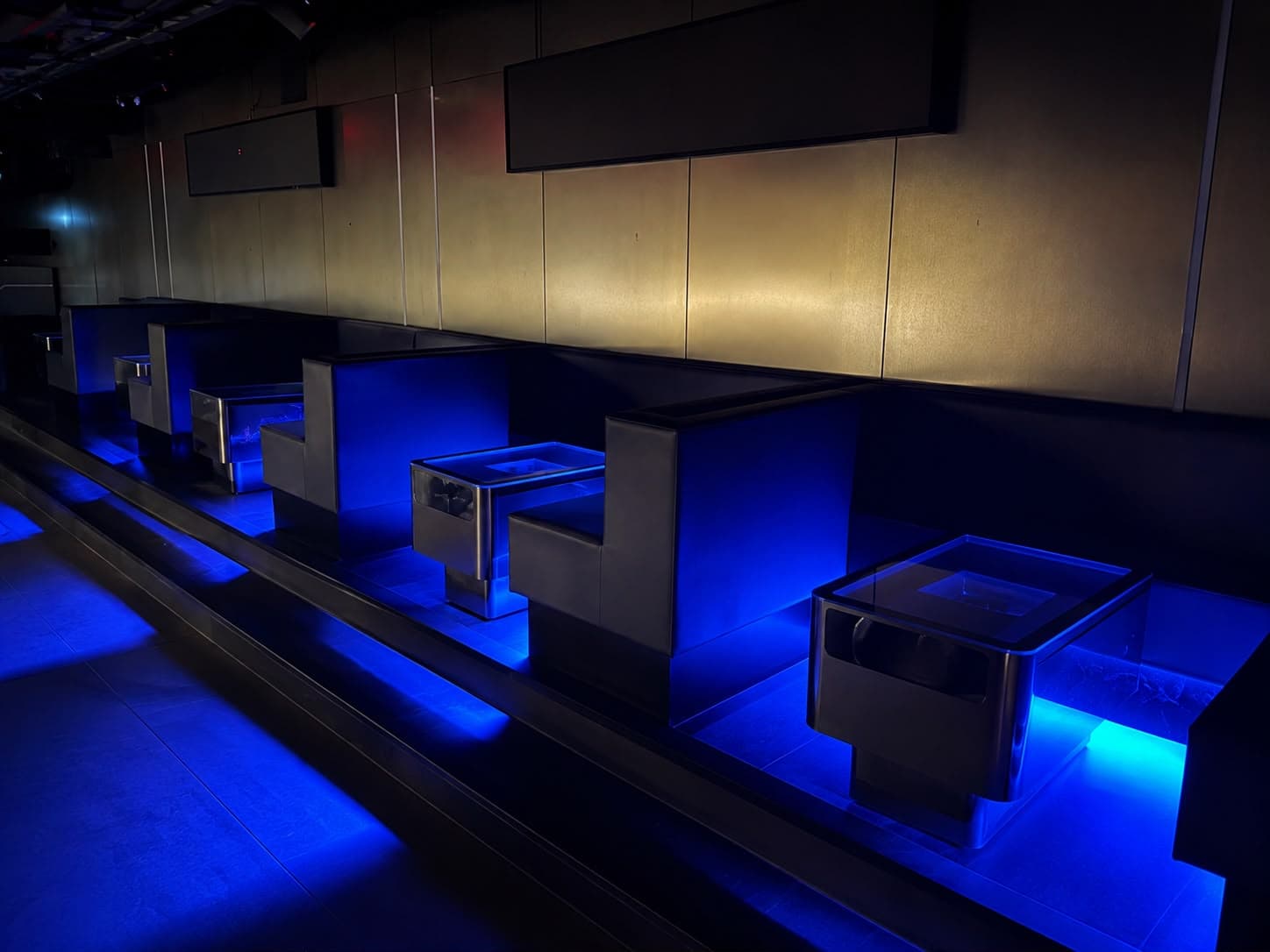 Dákiti's VIP booths, lit blue along the club's raised platform